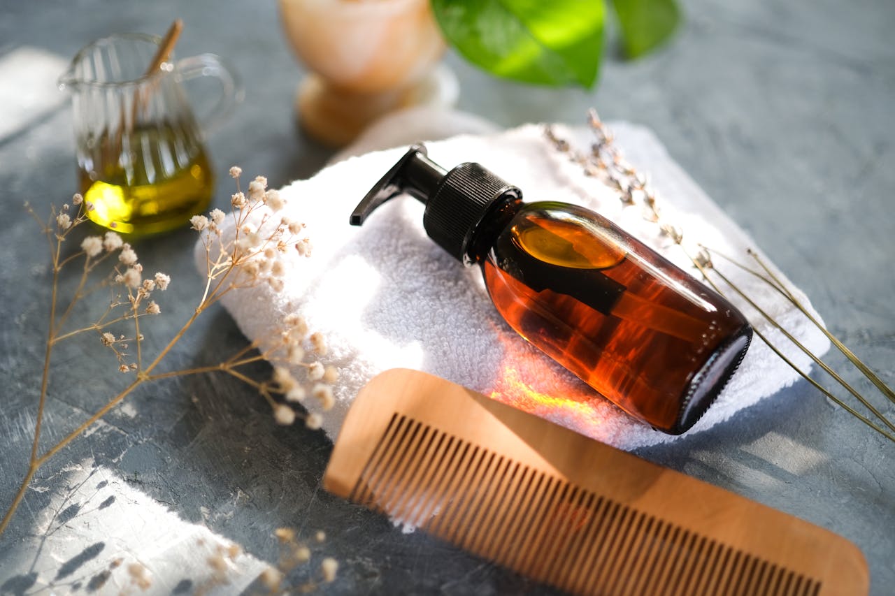 services-02 Elegant display of hair care accessories with natural elements and a wooden comb.